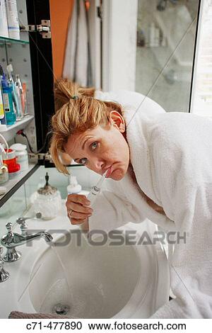 40's cacusian woman brushing teeth View Large Photo Image Stock Image - 40's cacusian woman brushing teeth. Fotosearch