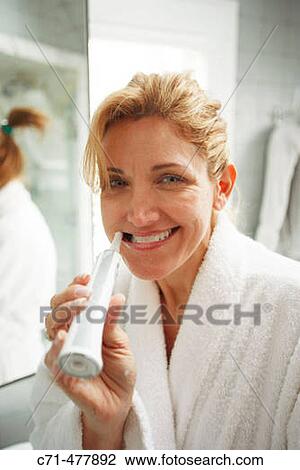 40's cacusian woman brushing teeth View Large Photo Image Stock Image - 40's cacusian woman brushing teeth. Fotosearch