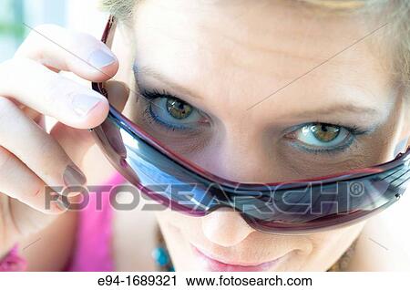 41 year old blond woman looking over her sun glasses View Large Photo Image Stock Image - 41 year old blond woman looking over her sun glasses. Fotosearch