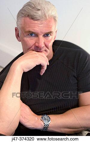 45 year old man, sitting head on hands serious expression View Large Photo Image Stock Image - 45 year old man, sitting head on hands serious expression. Fotosearch