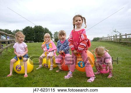 5 girs, aged 3-5 playing on bouncy hoppers, on a camping trip. View Large Photo Image Stock Photography - 5 girs, aged 3-5 playing on bouncy hoppers, on a camping trip.. Fotosearch
