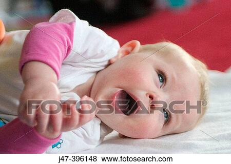 5 month old baby girl lying down yawning View Large Photo Image Stock Photo - 5 month old baby girl lying down yawning. Fotosearch