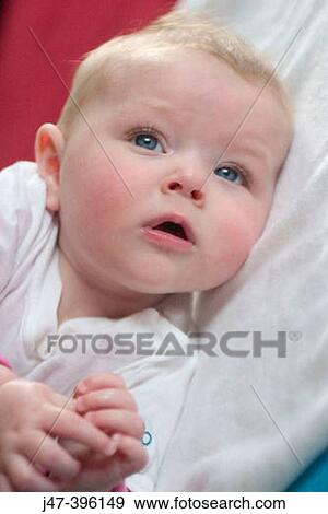 5 month old baby girl lying on side, serious, hands together View Large Photo Image Stock Photo - 5 month old baby girl lying on side, serious, hands together. Fotosearch