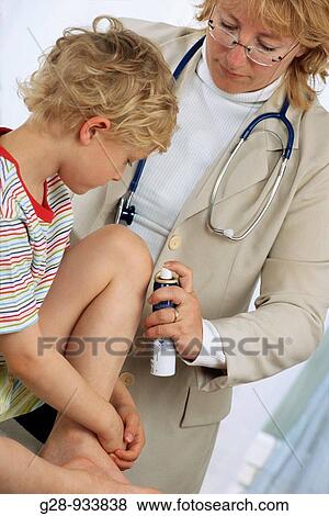 5 year old boy and doctor spraying clean a bruise View Large Photo Image Stock Photo - 5 year old boy and doctor spraying clean a bruise. Fotosearch