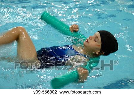 Stock Image - 5 year old girl in swimming pool. Fotosearch