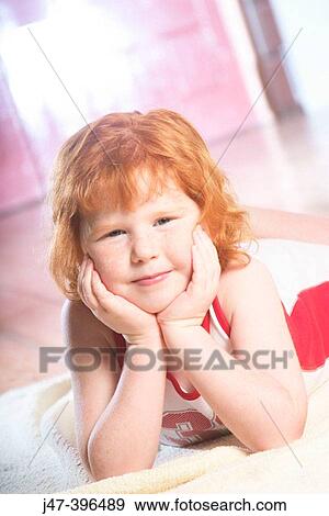 5 year old girl lying on her tummy, hands under her chin View Large Photo Image Stock Photo - 5 year old girl lying on her tummy, hands under her chin. Fotosearch