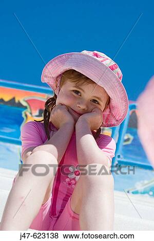 5 year old girl, sitting smiling into camera, wearing a swimsuit and sunhat, at the swimming baths View Large Photo Image Stock Photo - 5 year old girl, sitting smiling into camera, wearing a swimsuit and sunhat, at the swimming baths. Fotosearch