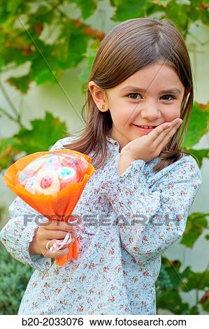 5 year old girl with treats. Donostia. San Sebastian. Gipuzkoa. Basque Country. Spain. View Large Photo Image Stock Photograph - 5 year old girl with treats. Donostia. San Sebastian. Gipuzkoa. Basque Country. Spain.. Fotosearch