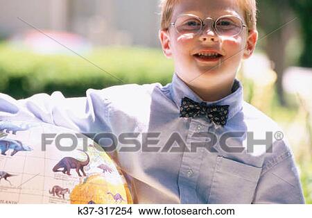 5 years old boy with reading glasses and bow tie holding globe with dinosaurs View Large Photo Image Picture - 5 years old boy with reading glasses and bow tie holding globe with dinosaurs. Fotosearch