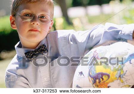 5 years old boy with reading glasses and bow tie holding globe with dinosaurs View Large Photo Image Stock Image - 5 years old boy with reading glasses and bow tie holding globe with dinosaurs. Fotosearch