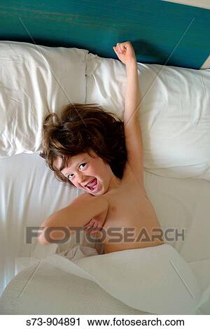 5 years old girl lying on a bed View Large Photo Image Stock Image - 5 years old girl lying on a bed. Fotosearch