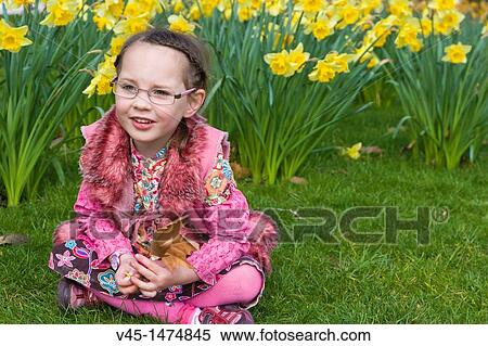 5 years old girl sitting on the lawn with daffodils at the background View Large Photo Image Stock Photography - 5 years old girl sitting on the lawn with daffodils at the background. Fotosearch