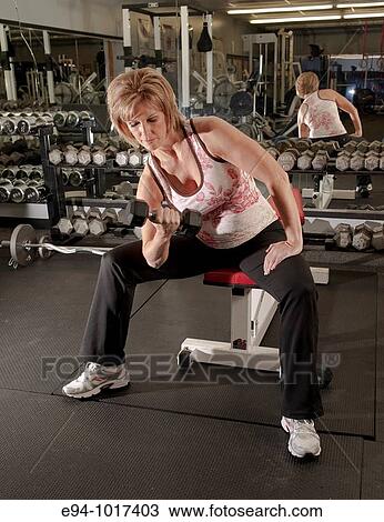 50 year old woman in health club setting working out with equipment View Large Photo Image Stock Image - 50 year old woman in health club setting working out with equipment. Fotosearch
