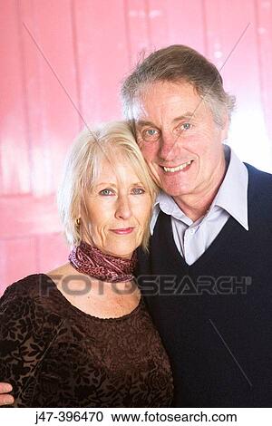 56 year old couple standing together, smiling into camera View Large Photo Image Stock Image - 56 year old couple standing together, smiling into camera. Fotosearch