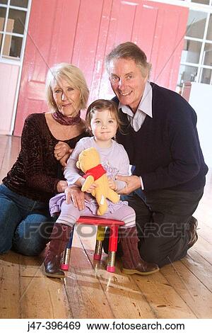 56 year old couple with their 3 year old grandaughter, smiling into camera View Large Photo Image Stock Photo - 56 year old couple with their 3 year old grandaughter, smiling into camera. Fotosearch