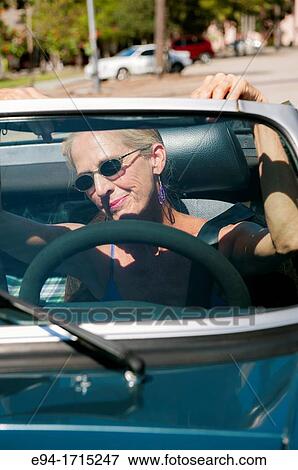 57 year old woman driving her MG convertible car looking through the windshield View Large Photo Image Stock Photo - 57 year old woman driving her MG convertible car looking through the windshield. Fotosearch