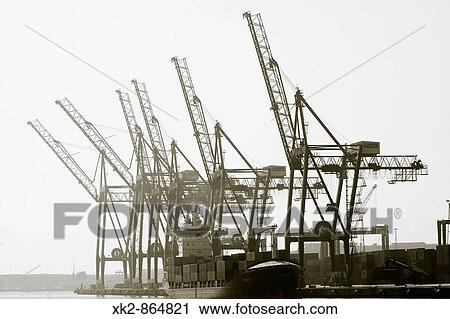 Stock Image - 6 Cranes and cargo ship, port of Barcelona, Catalunya, Spain. Fotosearch