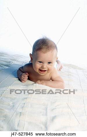 6 month old baby, lying on his tummy laughing off camera, lifting his head up View Large Photo Image Stock Photography - 6 month old baby, lying on his tummy laughing off camera, lifting his head up. Fotosearch
