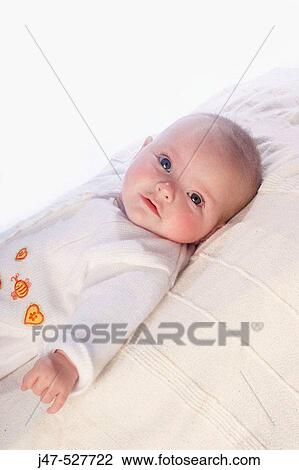6 month old baby lying on the floorr gazing off camera View Large Photo Image Stock Image - 6 month old baby lying on the floorr gazing off camera. Fotosearch