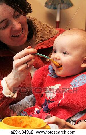6 month old boy eating View Large Photo Image Stock Image - 6 month old boy eating. Fotosearch
