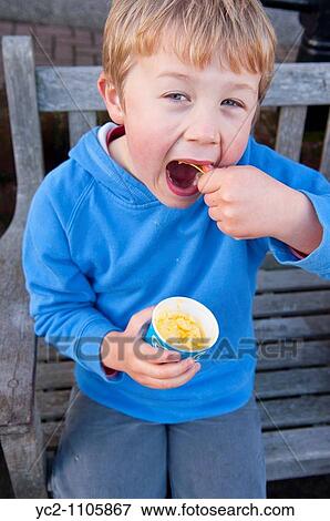 6 year old boy eating a tub of ice cream in the Uk View Large Photo Image Stock Photo - 6 year old boy eating a tub of ice cream in the Uk. Fotosearch
