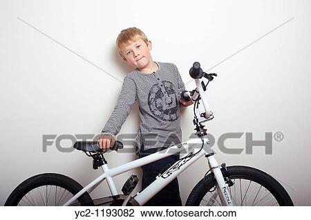 6 year old boy sitting on his brand new BMX bike in the studio looking proud View Large Photo Image Stock Image - 6 year old boy sitting on his brand new BMX bike in the studio looking proud. Fotosearch
