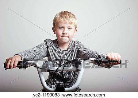 6 year old boy sitting on his brand new BMX bike in the studio looking proud View Large Photo Image Stock Image - 6 year old boy sitting on his brand new BMX bike in the studio looking proud. Fotosearch