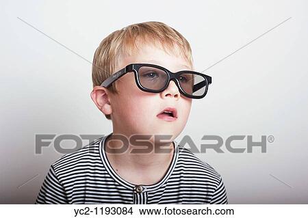6 year old boy wearing a pair of real 3d glasses in the studio View Large Photo Image Picture - 6 year old boy wearing a pair of real 3d glasses in the studio. Fotosearch