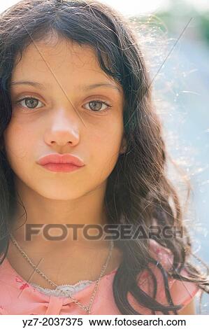 Stock Photography - 6 year old girl with serious expression looking into camera.. Fotosearch