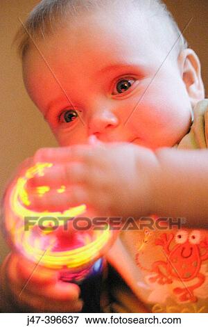 7 month old baby holding flashing light View Large Photo Image Stock Photo - 7 month old baby holding flashing light. Fotosearch