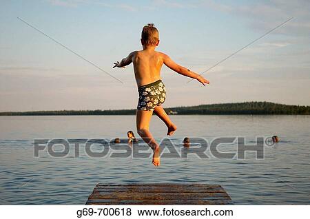 7 year old boy and jumping from a jetty, Norrbotten, Sweden (July 2005) View Large Photo Image Stock Photo - 7 year old boy and jumping from a jetty, Norrbotten, Sweden (July 2005). Fotosearch