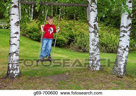 7 year old boy on a swing, Vasterbotten, Sweden (June 2005) View Large Photo Image Stock Image - 7 year old boy on a swing, Vasterbotten, Sweden (June 2005). Fotosearch