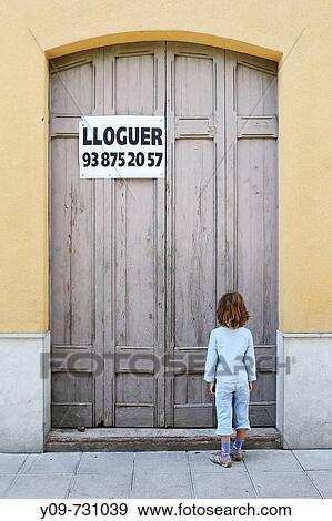 Stock Photo - 7 year old girl in front of closed wooden door with? for rent? sign. Fotosearch