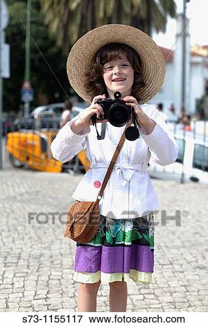7 year old girl smiling into camera, holding a camera round her neck View Large Photo Image Stock Photo - 7 year old girl smiling into camera, holding a camera round her neck. Fotosearch