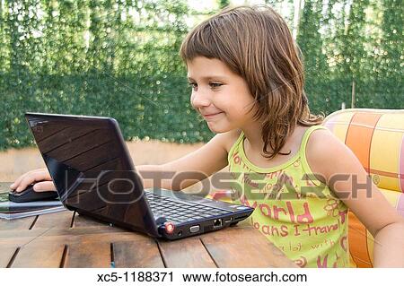 7 years old girl learning with a laptop View Large Photo Image Stock Image - 7 years old girl learning with a laptop. Fotosearch