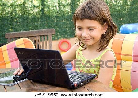 7 years old girl learning with a laptop View Large Photo Image Stock Image - 7 years old girl learning with a laptop. Fotosearch