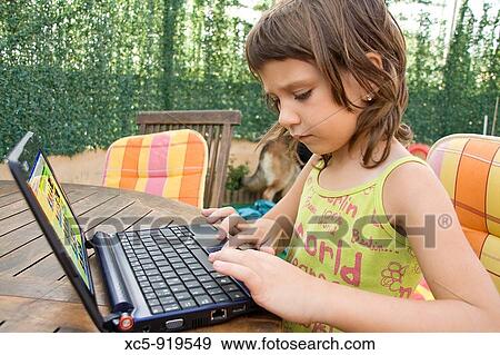 7 years old girl learning with a laptop View Large Photo Image Stock Photo - 7 years old girl learning with a laptop. Fotosearch