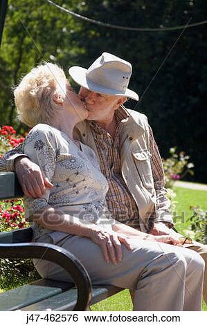 70 year old man sitting on a park kissing his wife age 69 View Large Photo Image Stock Photograph - 70 year old man sitting on a park kissing his wife age 69. Fotosearch