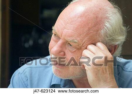 70 year old man with grey hair and a beard, looking pensive off camera, leaning his head on his hand View Large Photo Image Picture - 70 year old man with grey hair and a beard, looking pensive off camera, leaning his head on his hand. Fotosearch