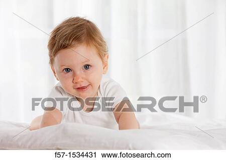 Stock Image - 8 month old baby boy. Fotosearch