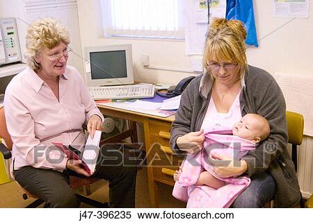 8 week old baby at doctors surgery, having her first health check-up with the health visitor View Large Photo Image Stock Photography - 8 week old baby at doctors surgery, having her first health check-up with the health visitor. Fotosearch