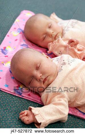 8 week old baby girls asleep twins, matching in pink View Large Photo Image Stock Image - 8 week old baby girls asleep twins, matching in pink. Fotosearch