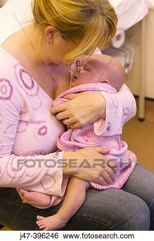 8 week old baby in mothers arms at doctors surgery after having her first injections View Large Photo Image Stock Photograph - 8 week old baby in mothers arms at doctors surgery after having her first injections. Fotosearch