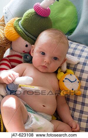8 week old baby sitting in a chair with all his teddies around him. View Large Photo Image Stock Photo - 8 week old baby sitting in a chair with all his teddies around him.. Fotosearch