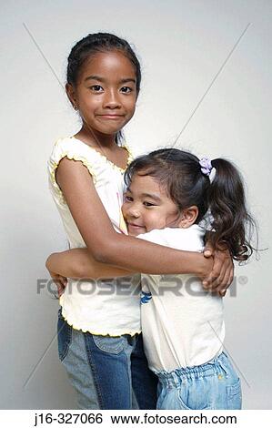 8 year old and 4 year old Asian Afro-American sisters View Large Photo Image Stock Photograph - 8 year old and 4 year old Asian Afro-American sisters. Fotosearch