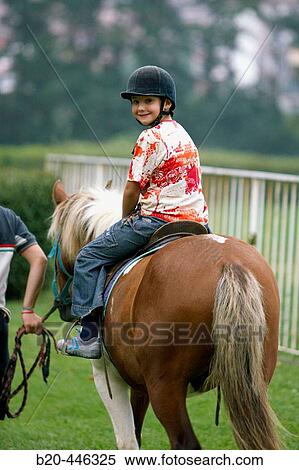 8 year old boy riding horse in the Lasarte racetrack, Donostia (San SebastiBn). Guipzcoa, Euskadi. Spain View Large Photo Image Stock Photography - 8 year old boy riding horse in the Lasarte racetrack, Donostia (San SebastiBn). Guipzcoa, Euskadi. Spain. Fotosearch
