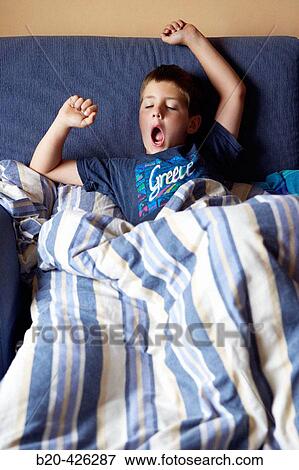 8 year old boy stretching View Large Photo Image Stock Photo - 8 year old boy stretching. Fotosearch