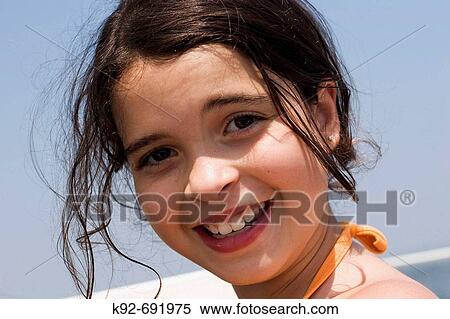 Stock Photography - 8 year old girl on a sailboat. Fotosearch
