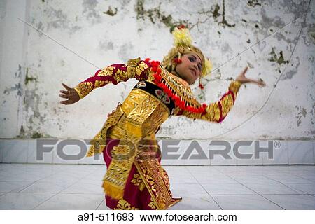 Stock Image - 8 years old female dancer at her dance teacher home for make-up and practising Legong Kraton dance. Gyanar. Island of Bali. Indonesia. Fotosearch