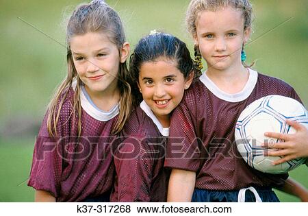 8 years old girls wearing school soccer team uniforms after playing a game View Large Photo Image Stock Photo - 8 years old girls wearing school soccer team uniforms after playing a game. Fotosearch